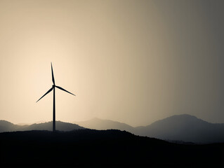 Wind turbine generating clean energy at sunset in mountainous landscape