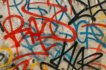 Colorful graffiti on textured wall with abstract patterns and de