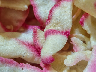 White rice crackers with bright pink accents, appetizingly displaying a crunchy texture,...