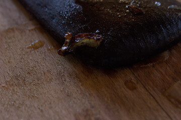 Wooden spatula stained with onion on a wooden cutting board