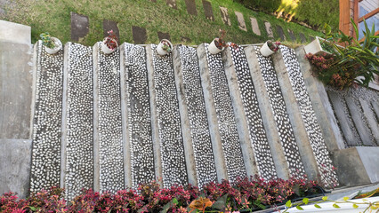 Minimalist concrete stairs with white stone decoration in a newly constructed outdoor garden area...