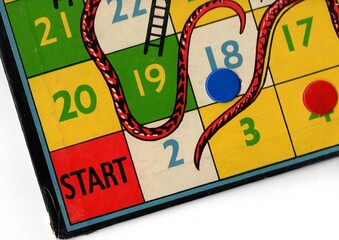 Detail from a vintage snakes and ladders game board. © Philip