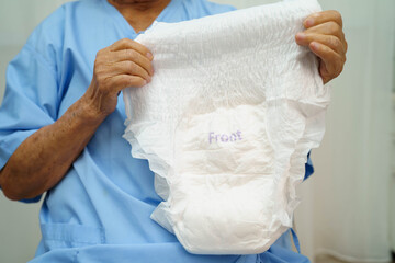 Fototapeta premium Asian senior woman patient wearing adult incontinence diaper pad in hospital.