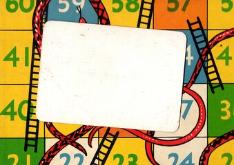 Detail from a vintage snakes and ladders game board with a panel for text. © Philip