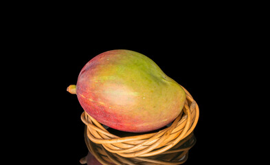 Ripe juicy mangoes on a black background, close-up.