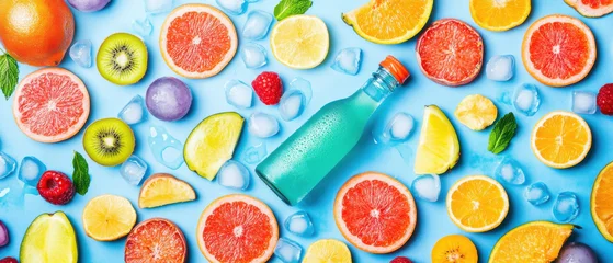 Papier peint photo  Bright flat lay of colorful citrus fruit slices, kiwi, raspberries, and blue bottle with ice cubes creating fresh and vibrant  © nattapon98