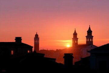 Fototapeta premium Silhouetted bell towers and rooftops during Venice sunset, warm tones and romantic mood