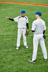 Obraz premium Teenage boys strategizing on a sunny baseball field during practice