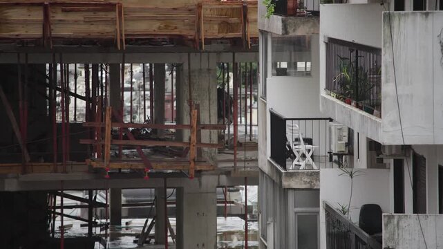 Rainy day in Recoleta, Buenos Aires: gray urban landscape filmed from an apartment. Wet streets, overcast sky, and construction in the rain. Detailed shots with interior references. 