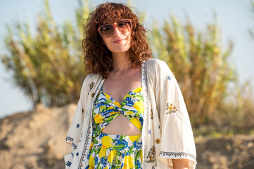 Stylish Woman in Summer Lemon Dress and Embroidered Kimono Outdoors