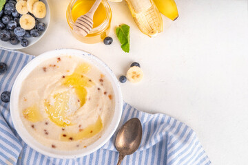 Sweet breakfast farina porridge with butter, honey and fruits. American creamy milled wheat flour porridge, hot breakfast cereal