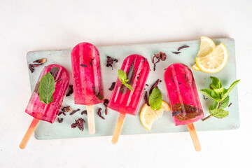 Frozen Hibiscus Water lollipops, sweet Hibiscus tea popsicles with lemon and mint, low-calorie healthy gelato