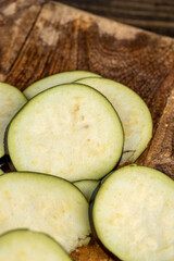 cut purple eggplant , sliced ripe eggplant on the table before cooking, close up