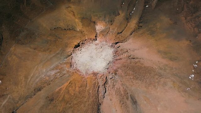 Top-down aerial rotation over the crater of Mount Teide volcano during sunset, Teide National Park, Tenerife, Canary Islands