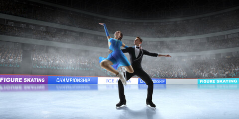 Figure skating pair skating on ice stadium.