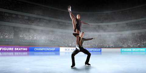 Figure skating couple skating on ice stadium.