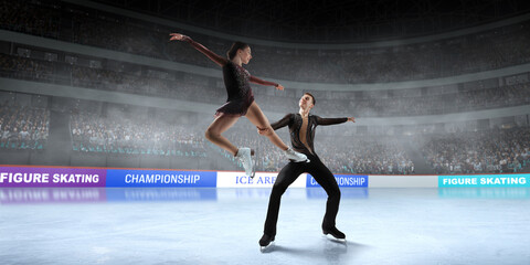 Figure skating couple skating on ice stadium.
