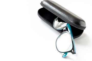 Stylish eyeglasses with glasses case on white. Eye care and protection concept