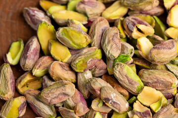 pistachios chopped and crushed into pieces of different sizes, a bunch of green crunchy pistachios, closeup
