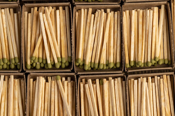 wooden matches with head in matchbox, the green head of a wooden match laid out in cardboard boxes,...
