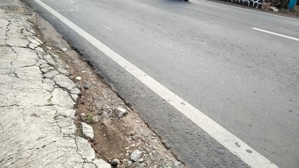 asphalt road in the street. pedestrian crossing on the street. stone wall texture. walking on the street. pedestrian crossing the road. asphalt road with a crack. asphalt road texture. asphalt road de