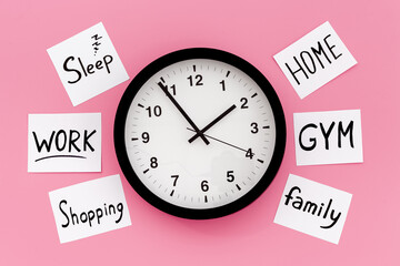 Wall clock and many paper cards with hand drawing of different life activities, top view. Time...