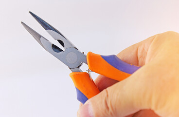 Hand holding electrical tools to assemble the electrical control panel. 
