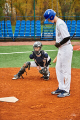 Two teenage boys engaged in an intense baseball match on a vibrant field
