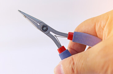 Hand holding electrical tools to assemble the electrical control panel. 