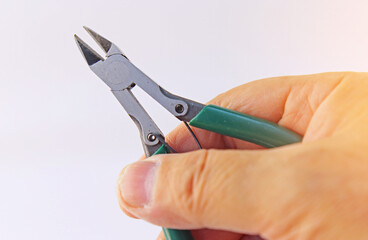 Hand holding electrical tools to assemble the electrical control panel. 
