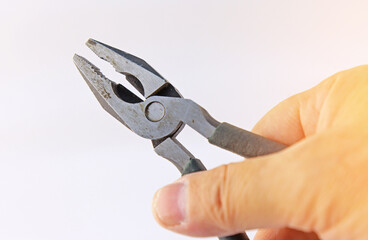 Hand holding electrical tools to assemble the electrical control panel. 