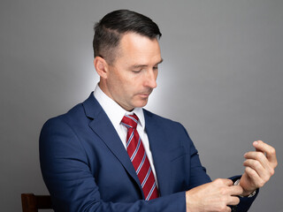Portrait of white male professional in a blue suit and red tie. 