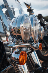 Harley-Davidson custom motorcycle headlight assembly, consisting of dual circular chrome headlights on exhibition at Motor Rock event for custom motorcycles.