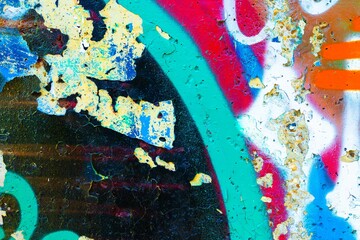 Vibrant graffiti texture in rusty blue, teal, red, orange. Urban 90s, grunge style, distressed surface, layered colors. Backgrounds, digital art, modern 90s, 2000s, Y2K creative banner, urban visuals.