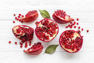 Fresh ripe pomegranate with half and pieces ready for eating. Top view