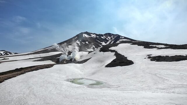 Snow-covered Mount Asahidake with Steam Vents in May, Daisetsuzan National Park, Hokkaido, Japan