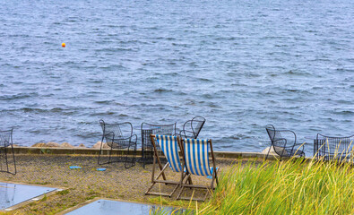 Two empty lounge chairs by the sea