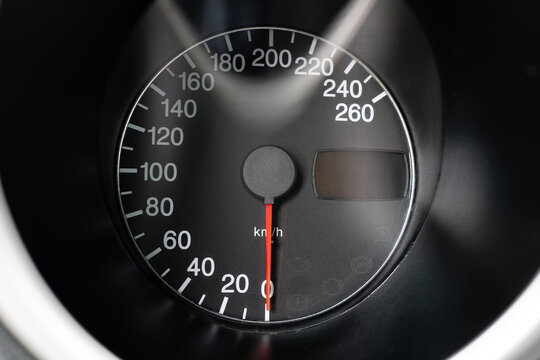 Car analog speedometer gauge in km/h. Close up macro shot, generic sports car, no people