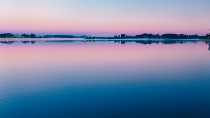Dawn breaks on the river.