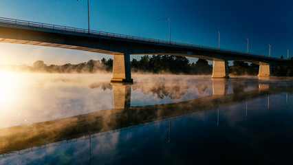 Rising mist as the morning sunlight heats up the river surface.