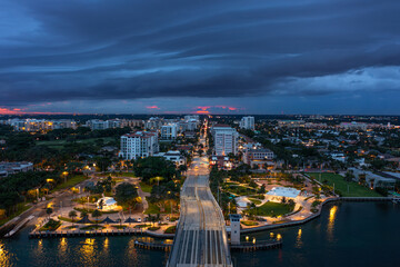 Dramatic Storm Shelf Cloud Over Boca Raton at Sunset – Aerial View of Florida Cityscape. Neon Pink Sun. 