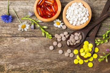 Alternative medicine herbal capsule organic drug on wooden background.Assortment of herbal and tablets,vitamins and dietary supplements.medicinal and Healing herbs.natural supplements for healthy life