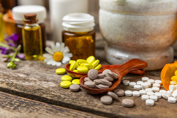 Alternative medicine herbal capsule organic drug on wooden background.Assortment of herbal and tablets,vitamins and dietary supplements.medicinal and Healing herbs.natural supplements for healthy life