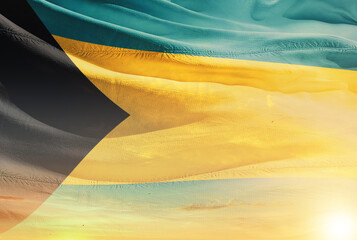 The Bahamas national flag waving in sunny sky with beautiful sunset. The Bahamas national flag for...