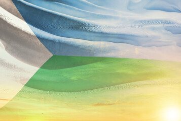 Djibouti national flag waving in sunny sky with beautiful sunset. Djibouti national flag for independence day.