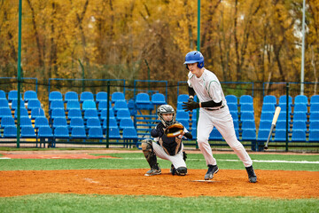 Teenage boys enjoying a spirited baseball game on a sunny afternoon field