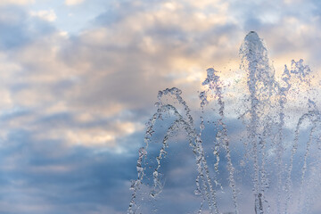 Splashes and jets of water against light background.