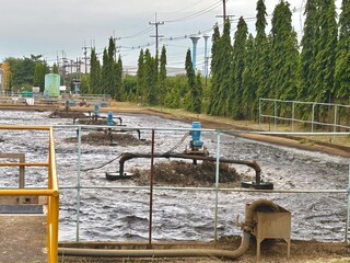 A large industrial wastewater treatment facility in Nong Kakha, Thailand, with aeration pumps...