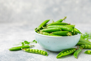 Fresh green pea pods with green peas on a wooden background. Sweet green peas. Green pea beans vegetables. Vegan. healthy vegetable. Copy space