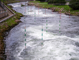 Detail of slalom gates on a whitewater course in Liptovský Mikuláš, Slovakia, with fast river...